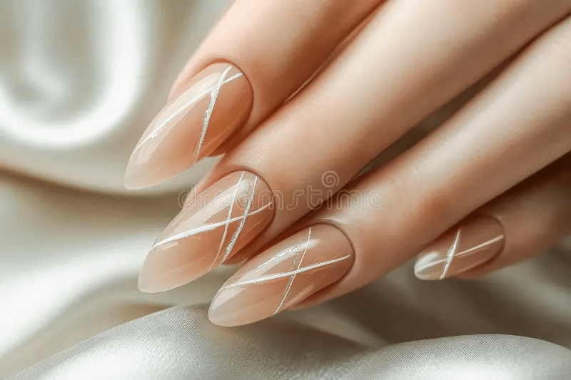 Close-up of peach nail paint with jewelry
