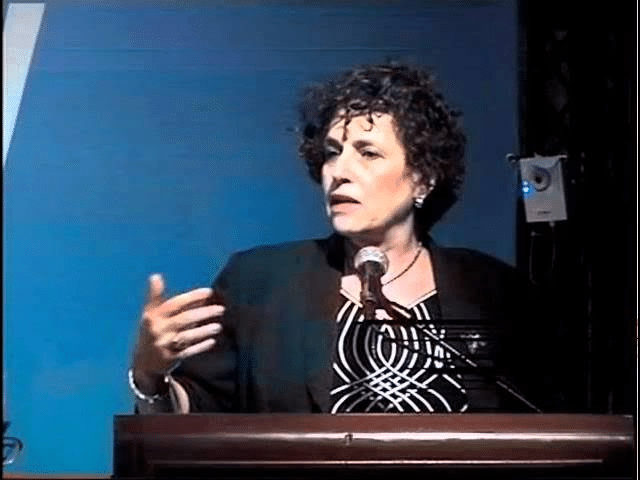 Miriam Haran speaking at a conference on environmental leadership
