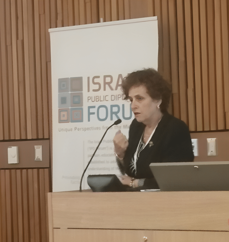 Miriam Haran discussing environmental policies at an international summit
