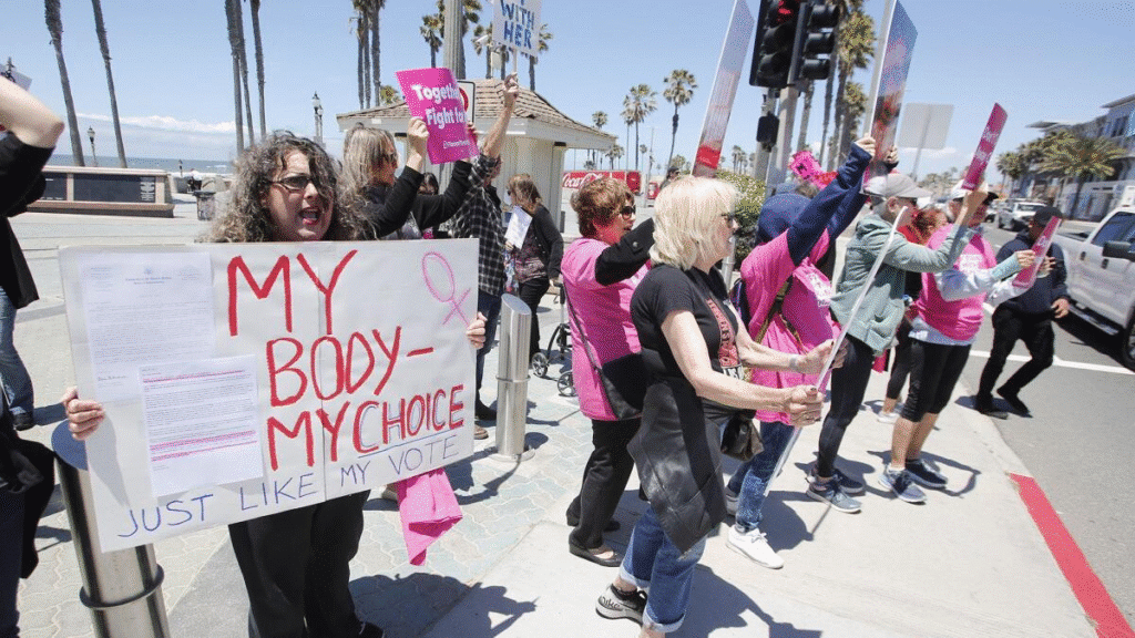 Protesters holding signs about bikini and women’s rights 