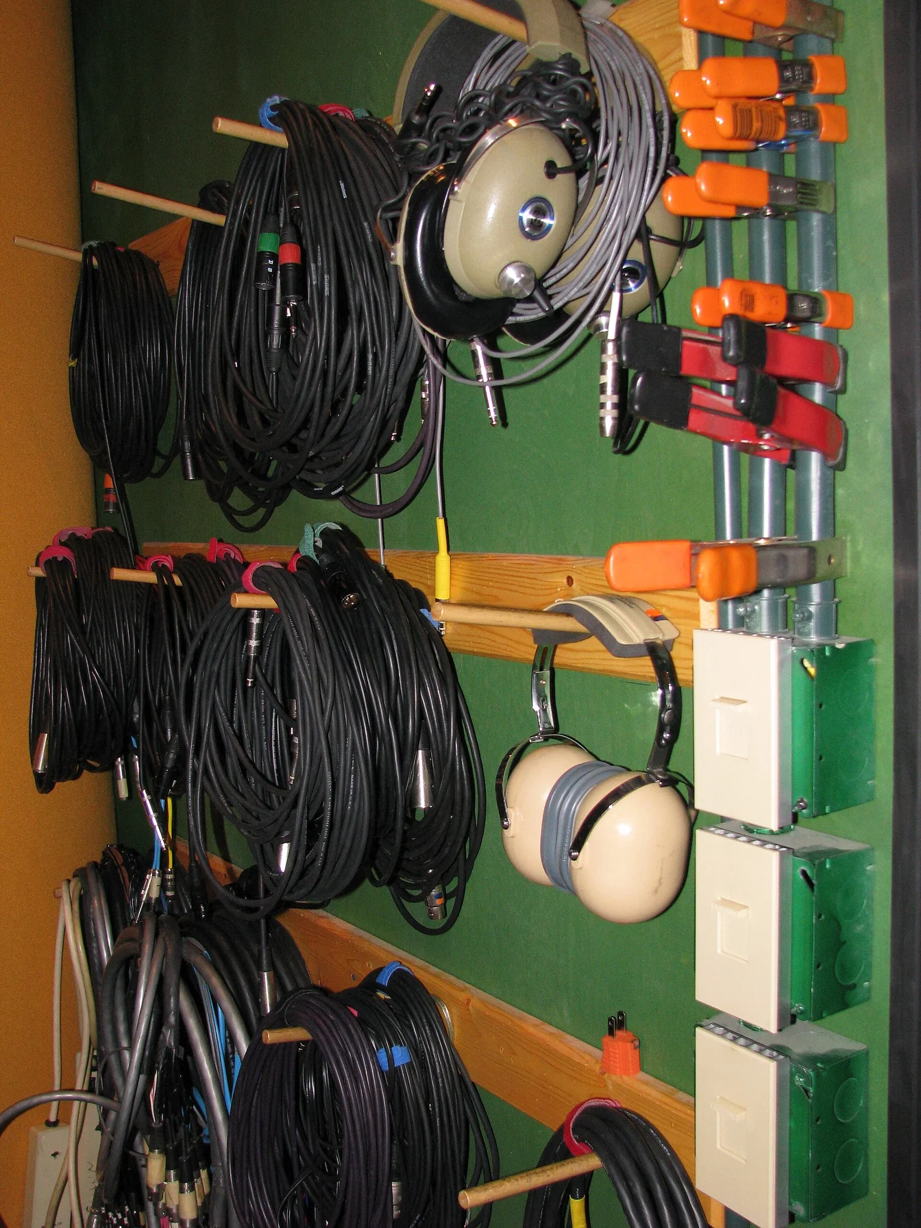 Billie Eilish in a recording studio, headphones on, focused expression