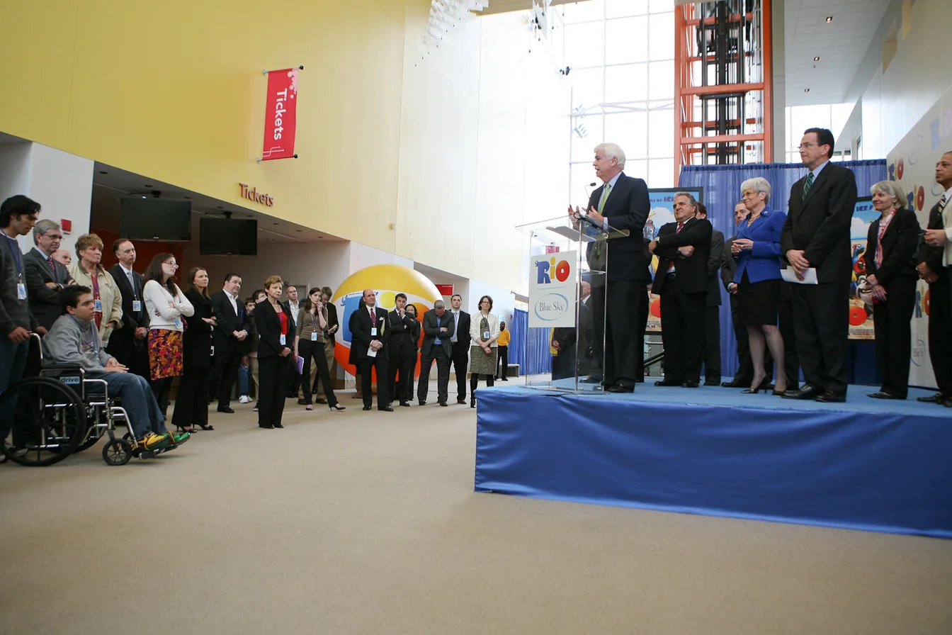 Ariana Grande and Ethan Slater at a Wicked movie event, smiling together on the red carpet
