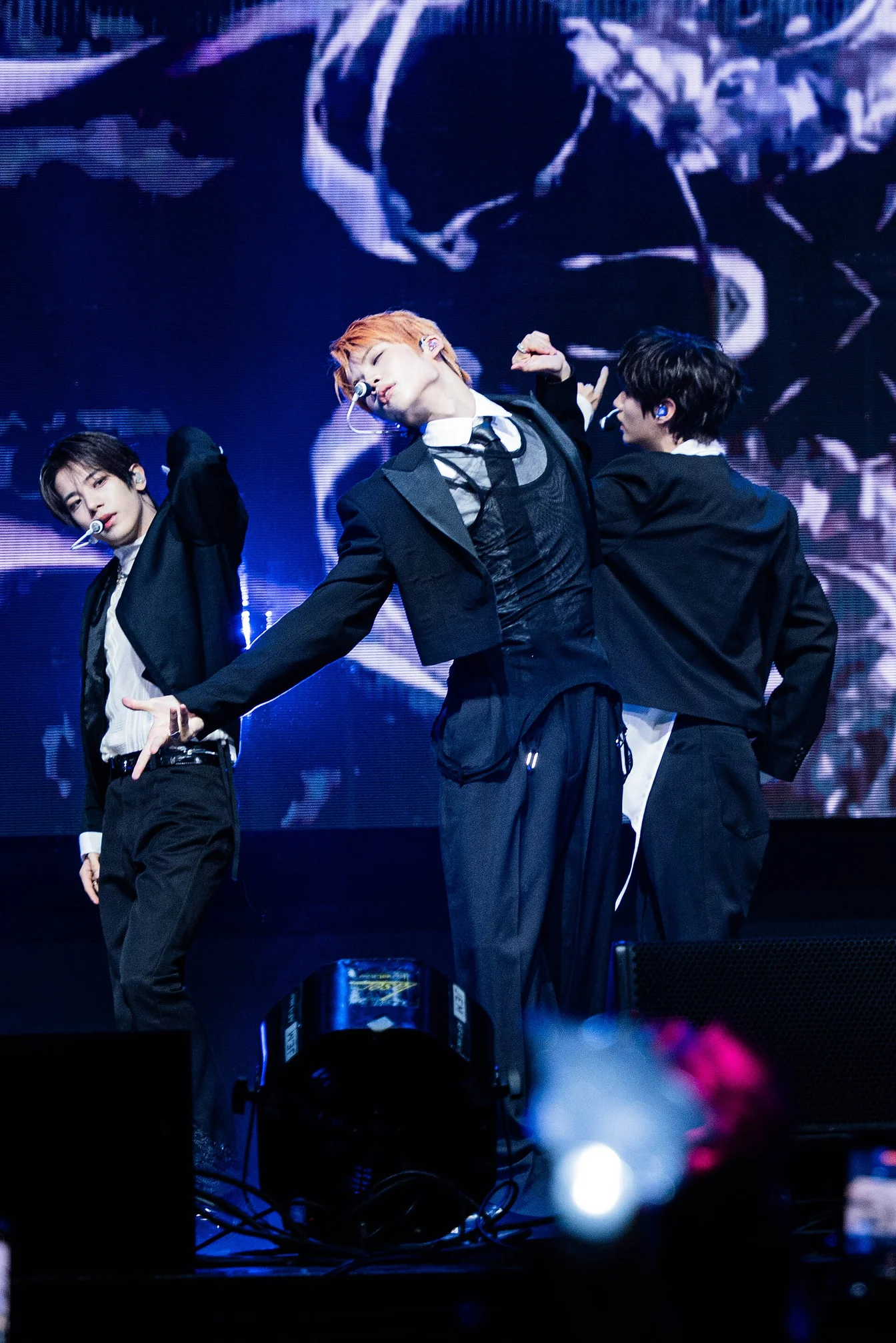 BTS members reuniting on stage, all seven members together with arms around each other