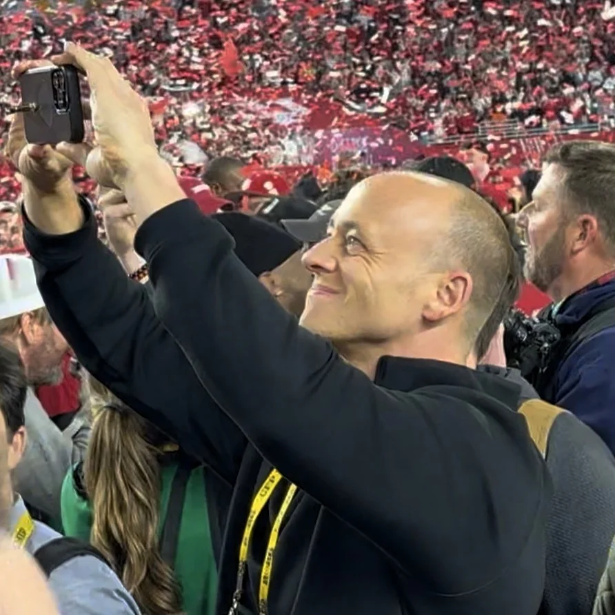 Travis Kelce and Taylor Swift celebrating on the field after Super Bowl LVIII with confetti