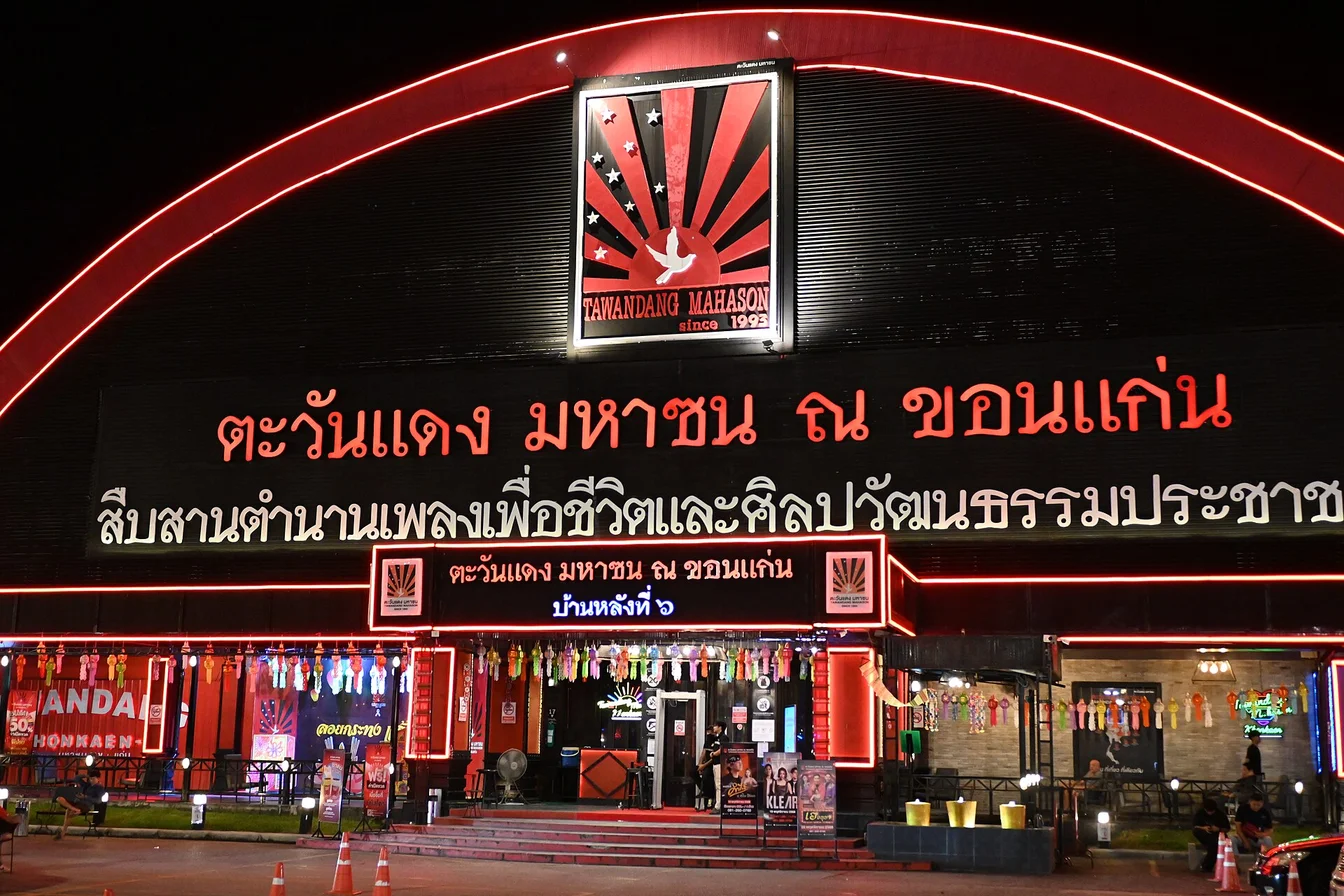 Concert venue at night with fans entering, showing the experience you’re fighting for