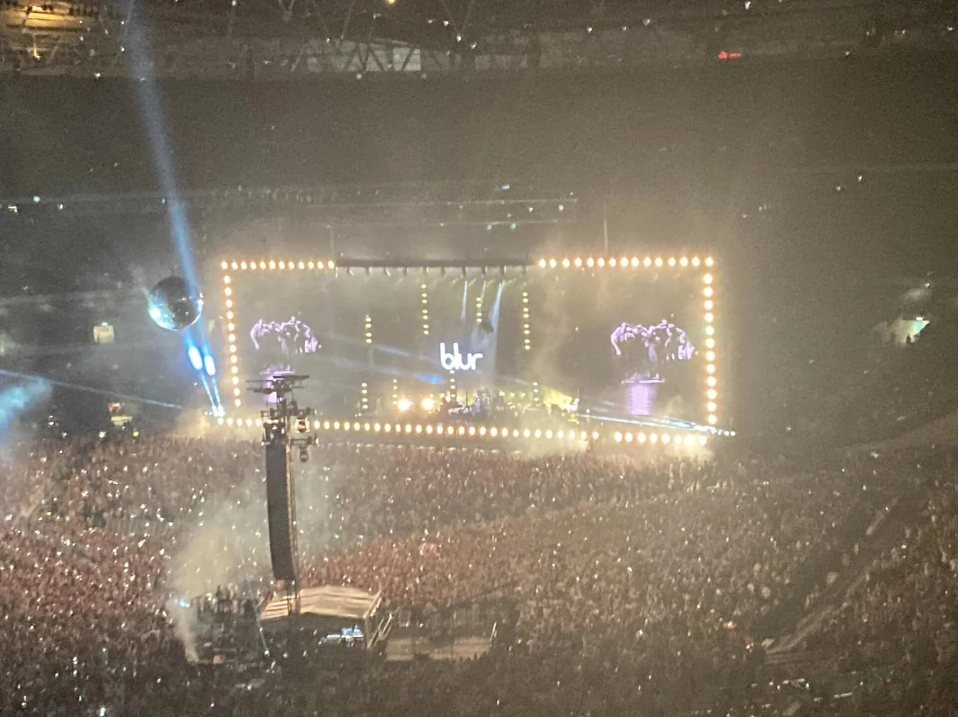 Fans with smart wristbands at pop icon stadium world tour, entire stadium lit up